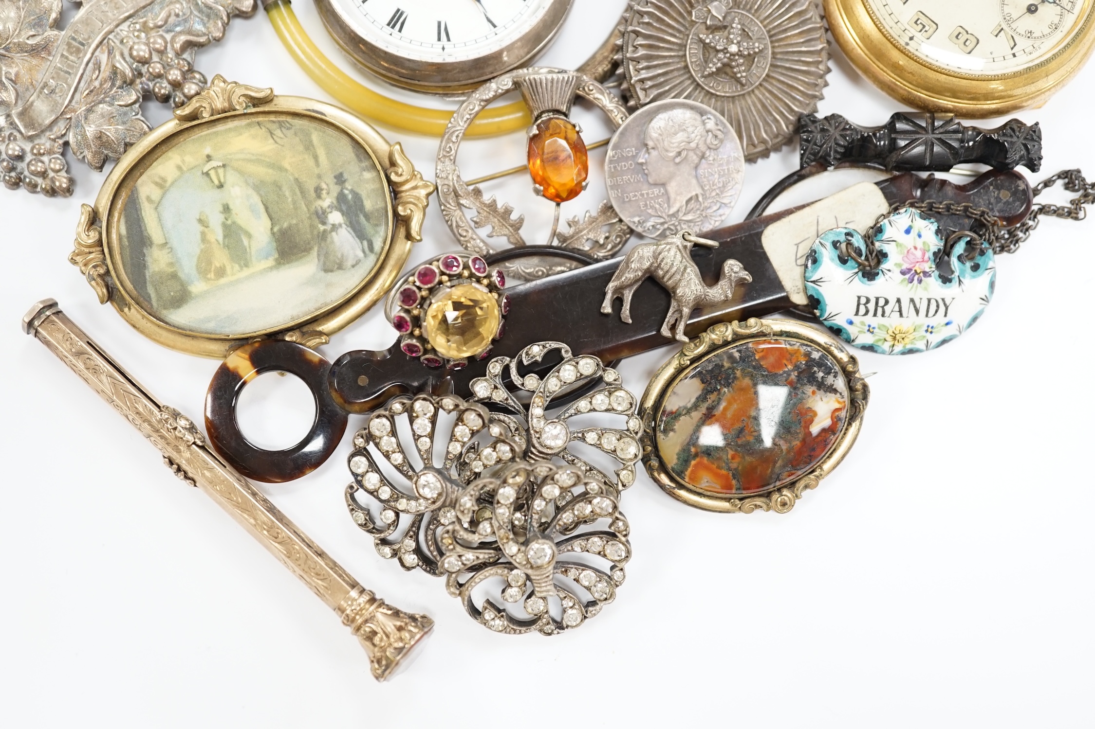 An interesting group of Victorian and later bijouterie, including mourning brooch, paste buckle, pocket watches, rings, wine label, etc.